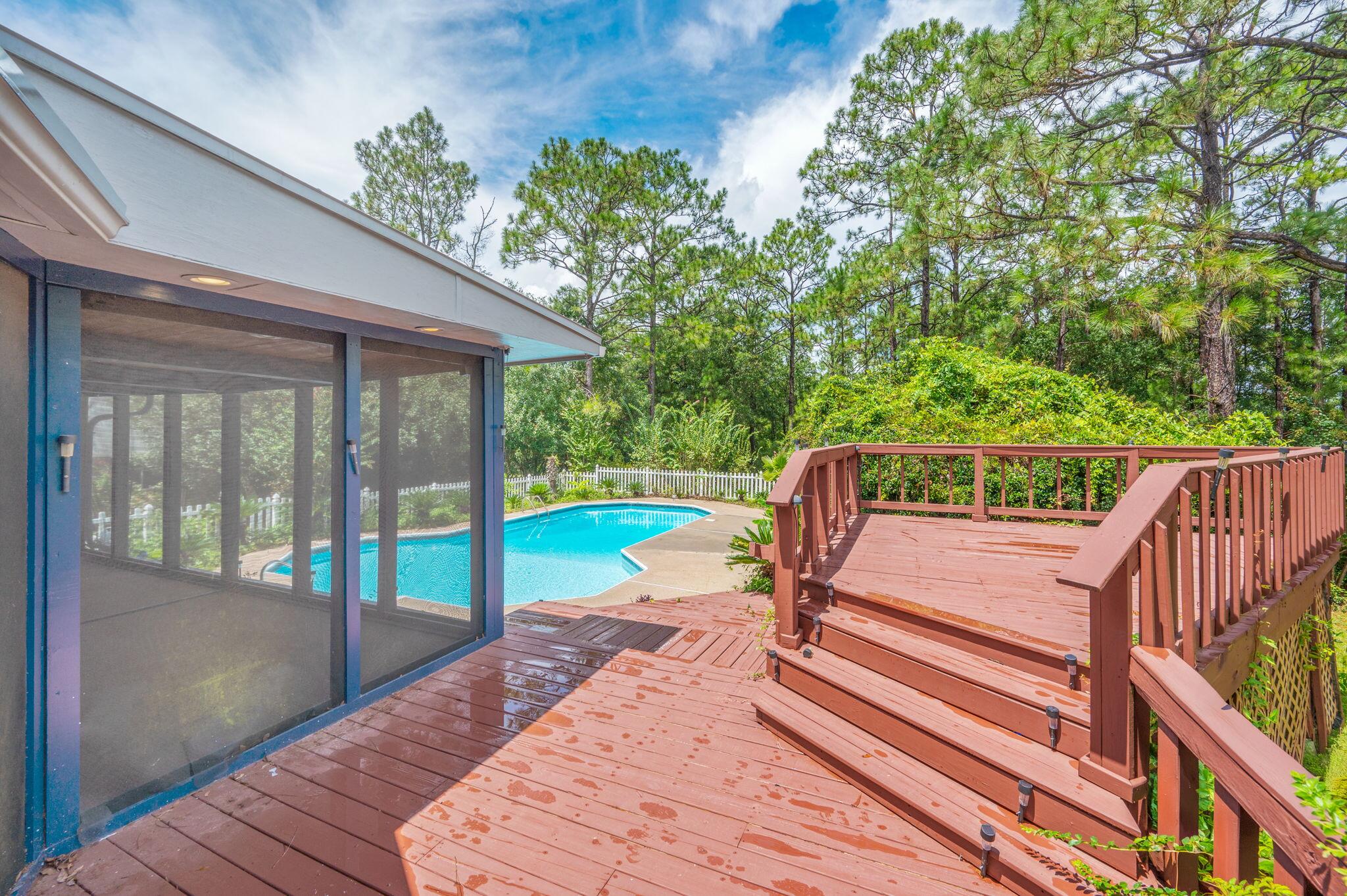 5770 Wildwood Road Crestview, FL 32536 - Photo 35 of 39 a view of a deck with a floor to ceiling window next to a yard
