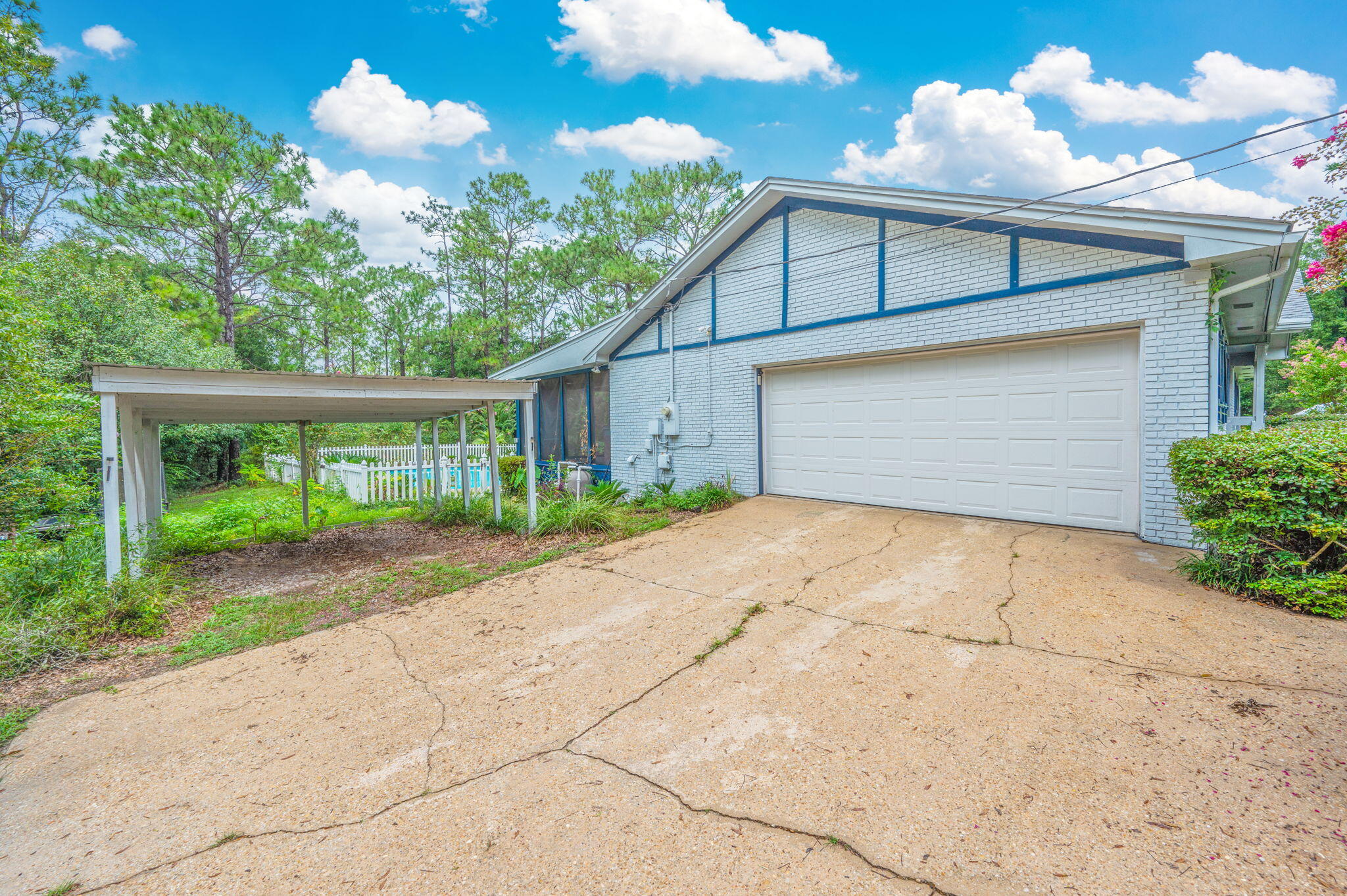 5770 Wildwood Road Crestview, FL 32536 - Photo 4 of 39 a front view of a house with a yard and a garage