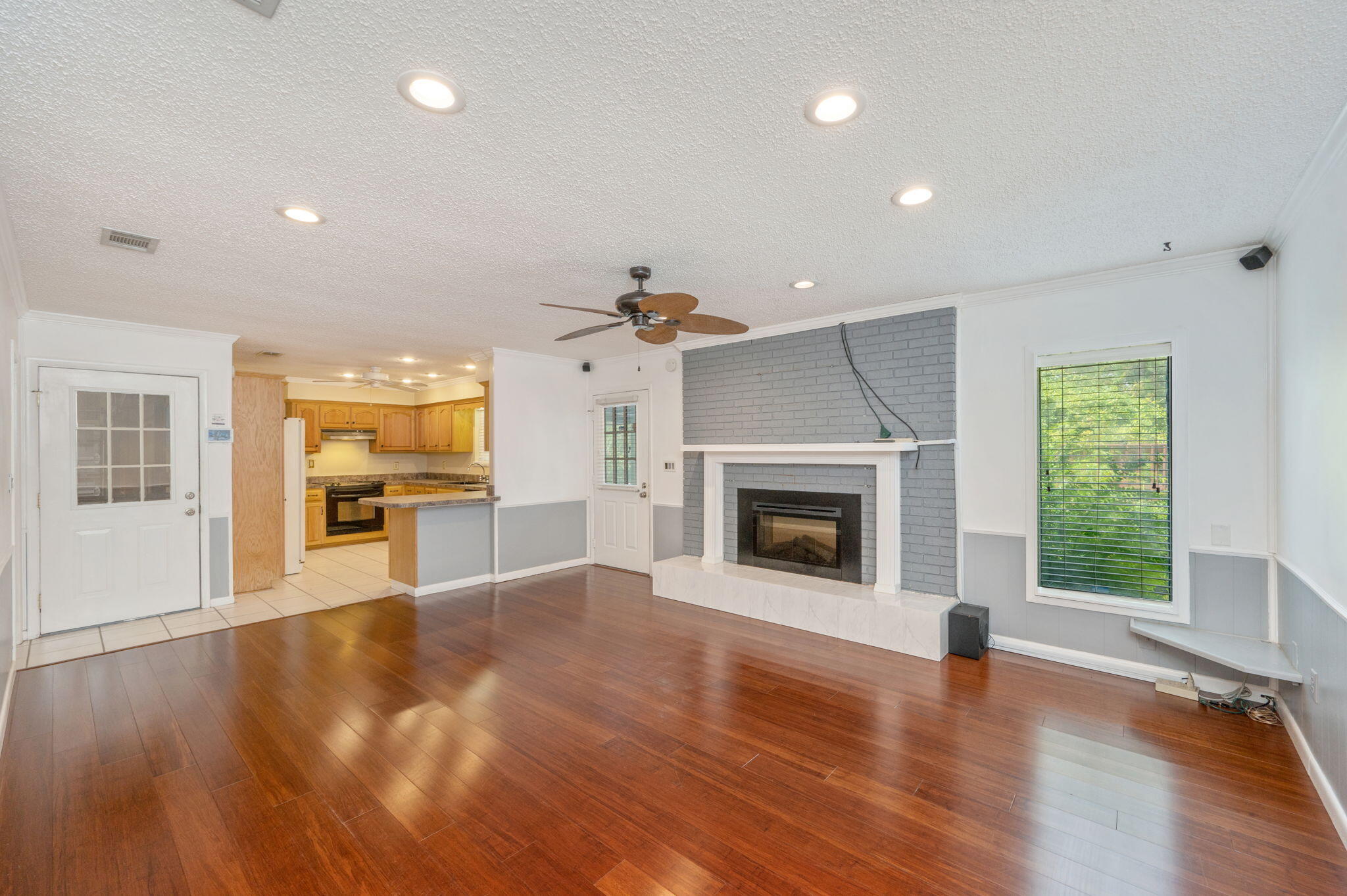 5770 Wildwood Road Crestview, FL 32536 - Photo 6 of 39 a view of a kitchen with a sink a fireplace and a window