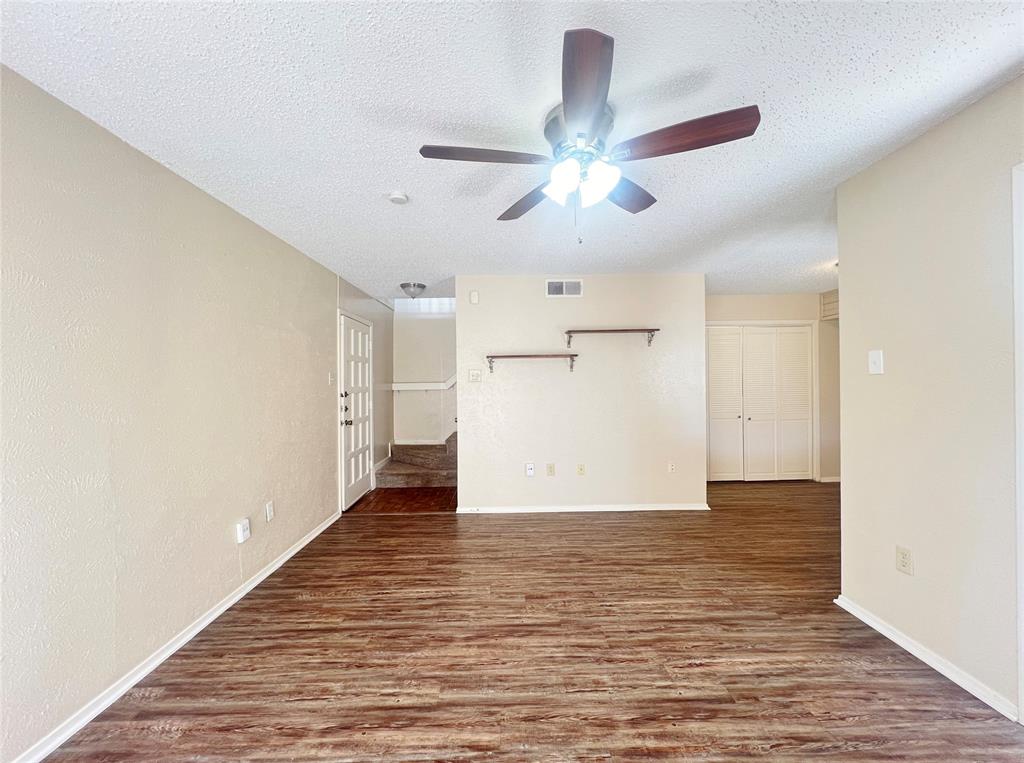 5626 Preston Oaks Road, Unit 43D Dallas, TX 75254 - Photo 2 of 9 a view of an empty room with wooden floor