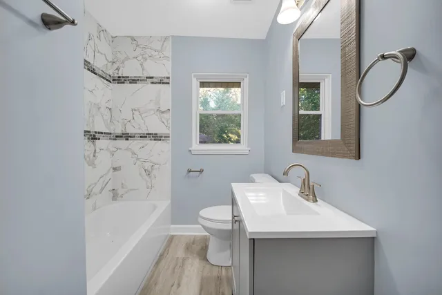 a bathroom with a sink toilet and shower