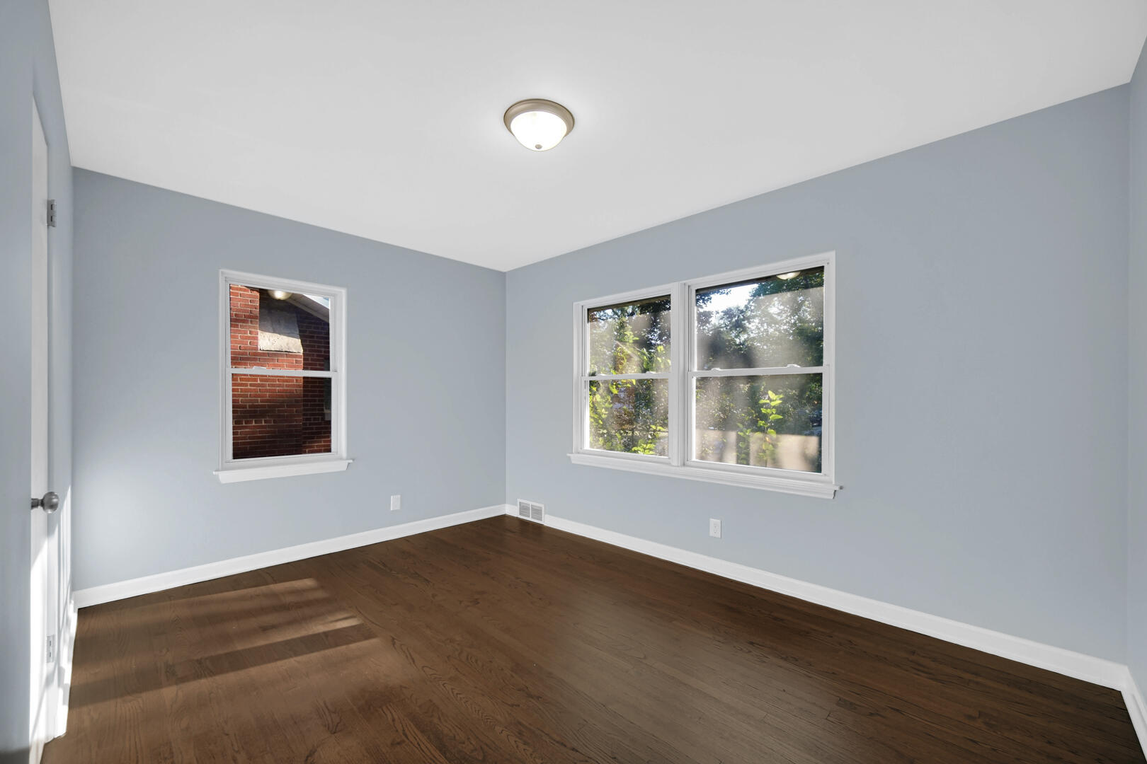 3816 Lincoln Street Gary, IN 46408 - Photo 13 of 21 a view of an empty room with wooden floor and a window