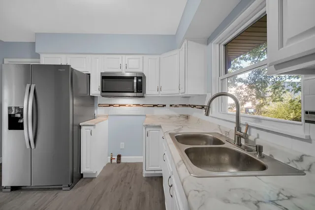 a kitchen with a sink cabinets and stainless steel appliances