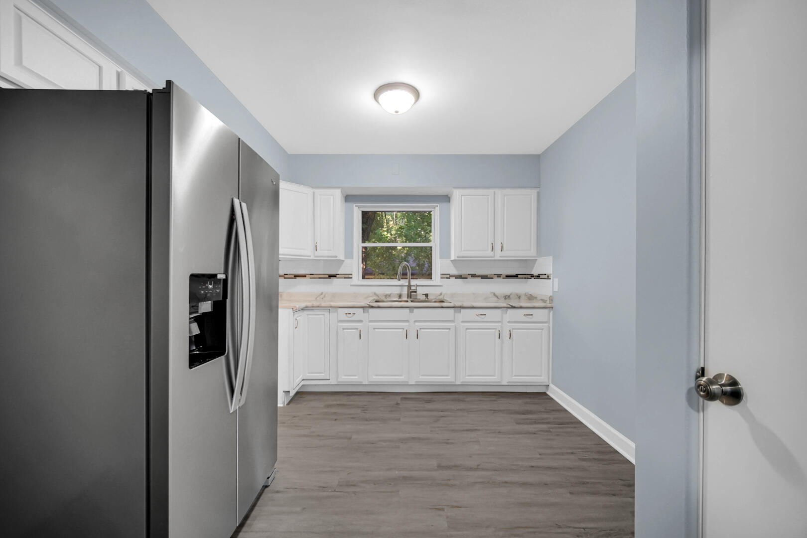 3816 Lincoln Street Gary, IN 46408 - Photo 9 of 21 a kitchen with a refrigerator and white cabinets