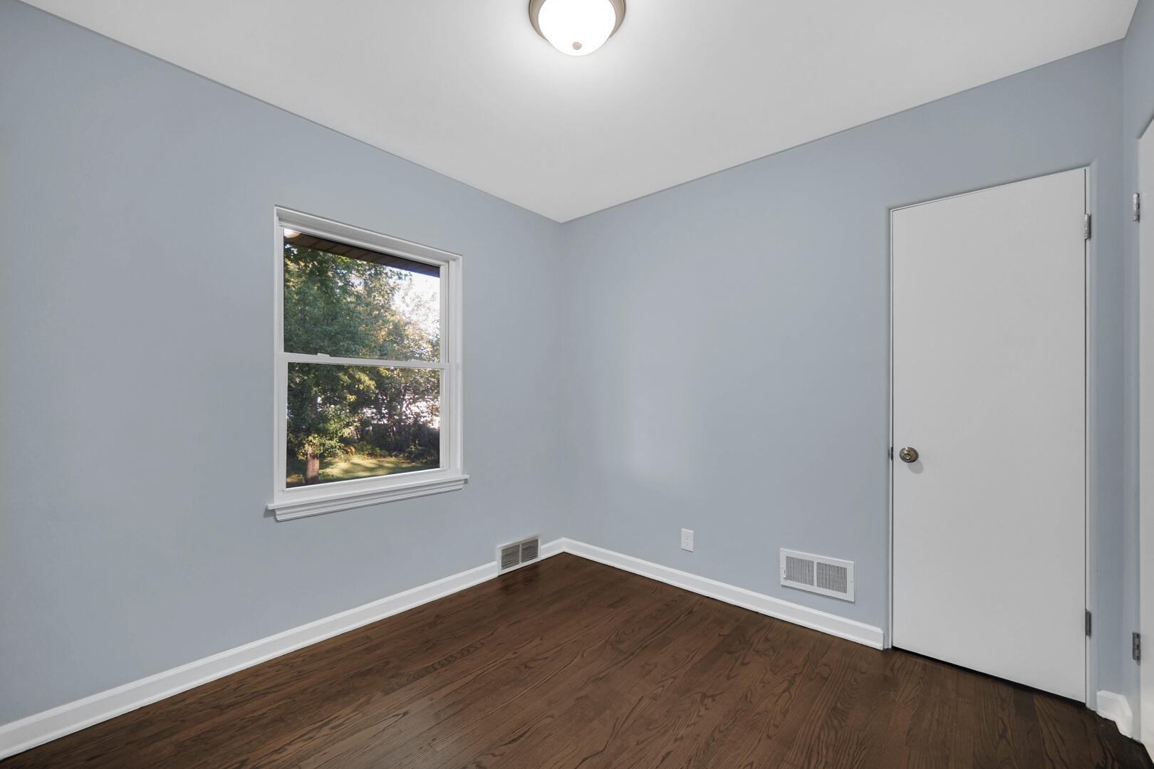3816 Lincoln Street Gary, IN 46408 - Photo 10 of 21 a view of an empty room with wooden floor and a window