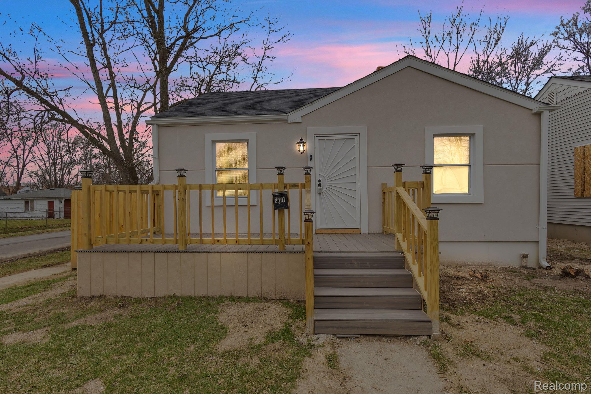 8401 Fielding Street Detroit, MI 48228 - Photo 3 of 34 Bungalow-style home featuring a deck, stucco siding, and a shingled roof