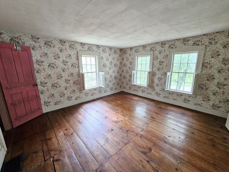 23 High Street Monson, MA 01057 - Photo 17 of 29 an empty room with wooden floor and windows