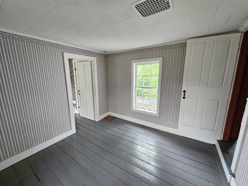 23 High Street Monson, MA 01057 - Photo 22 of 29 a view of an empty room with wooden floor and a window