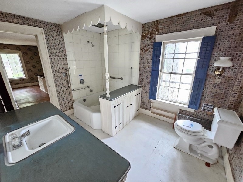 23 High Street Monson, MA 01057 - Photo 25 of 29 a spacious bathroom with a double vanity sink a mirror a bathtub and next to a window