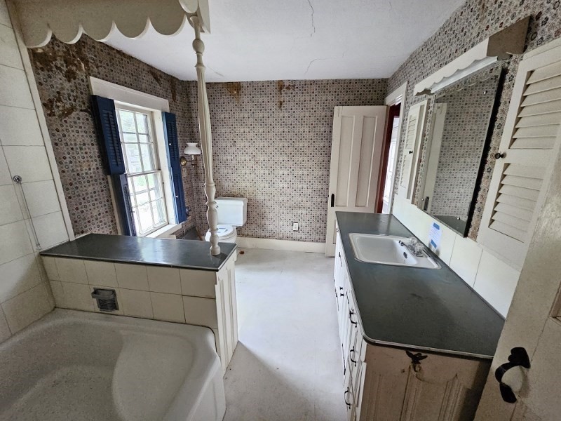 23 High Street Monson, MA 01057 - Photo 27 of 29 a bathroom with a sink a mirror and a bathtub