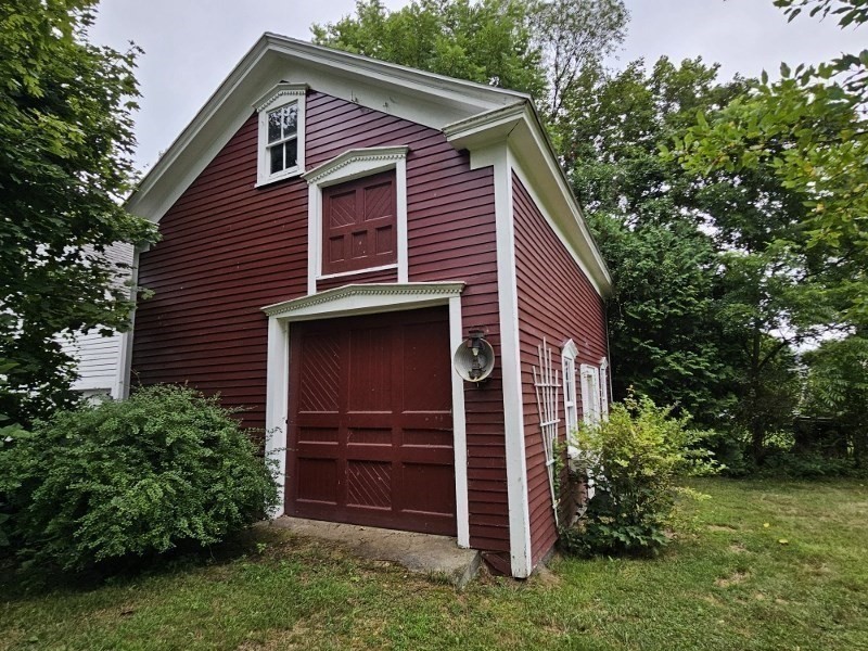 23 High Street Monson, MA 01057 - Photo 4 of 29 a front view of a house with a yard