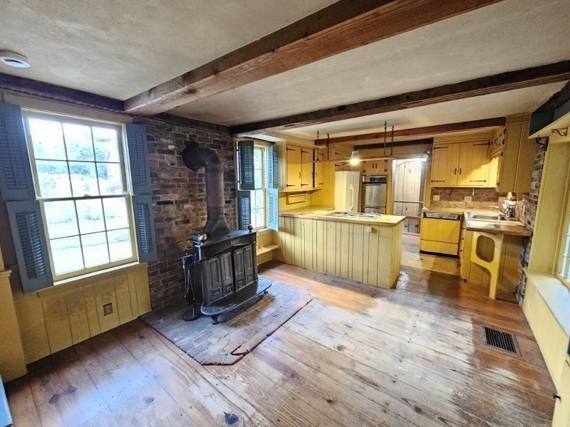 23 High Street Monson, MA 01057 - Photo 7 of 29 a living room filled with furniture hardwood floor and a kitchen