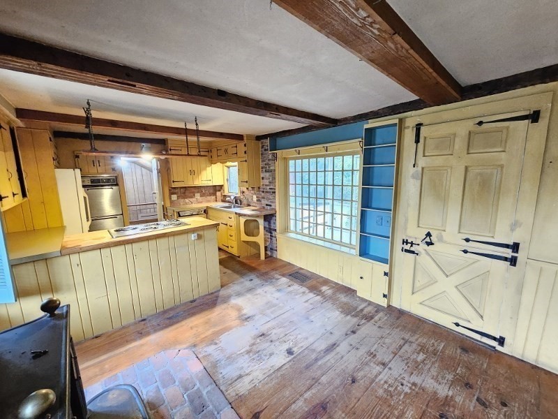 23 High Street Monson, MA 01057 - Photo 8 of 29 a view of a kitchen with wooden floor and electronic appliances