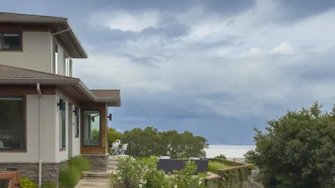 a view of a lake with couches in front of house