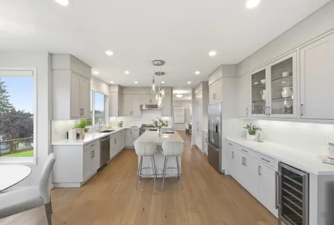 a kitchen with a table chairs sink and cabinets