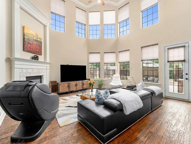 a living room with furniture fireplace and flat screen tv