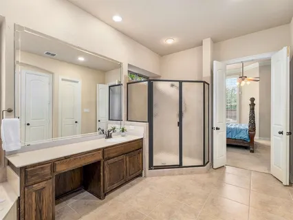 a bathroom with a double vanity sink mirror and shower