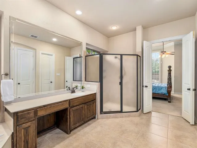 a bathroom with a double vanity sink mirror and shower