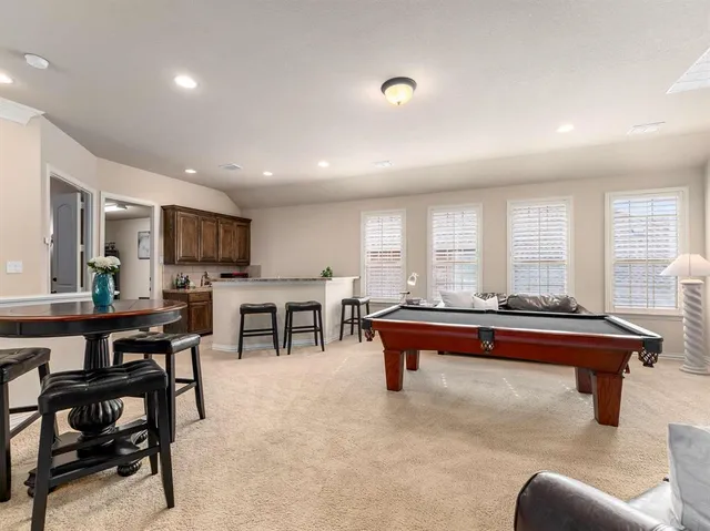 a living room with furniture a table and chairs