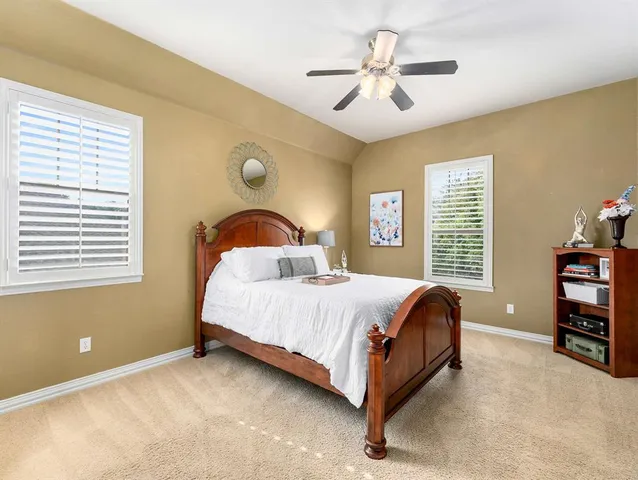 a bedroom with a bed dresser and a window