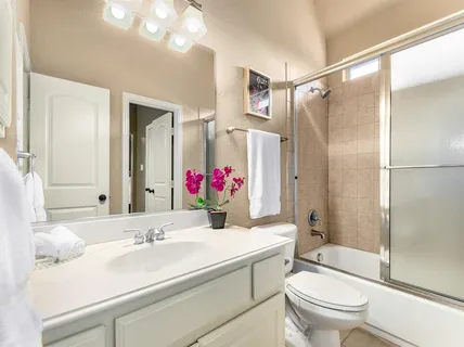 a bathroom with a sink vanity mirror and toilet