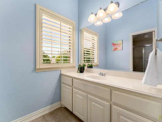 a bathroom with a sink a vanity and a mirror