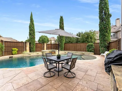 a view of a patio with a table and chairs