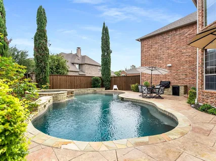 a view of a swimming pool with outdoor seating