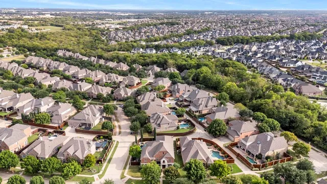 an aerial view of residential houses with outdoor space