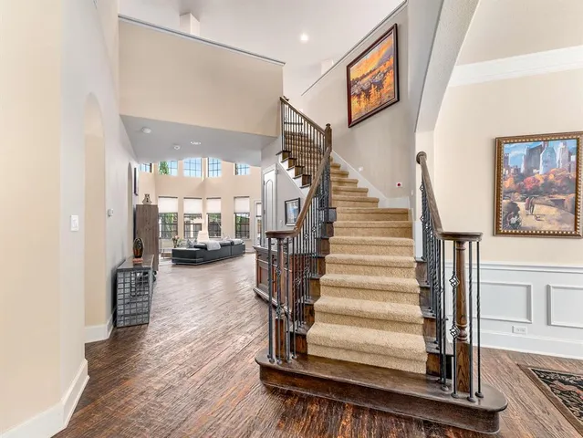 a view of entryway and hall with wooden floor