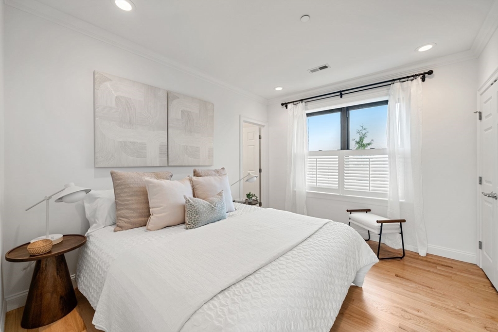 35 Rutherford Avenue, Unit 3 Boston, MA 02129 - Photo 13 of 28 a bedroom with a bed and a chair