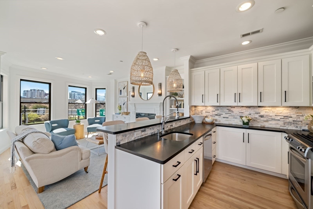 35 Rutherford Avenue, Unit 3 Boston, MA 02129 - Photo 2 of 28 a kitchen with granite countertop a sink and white cabinets