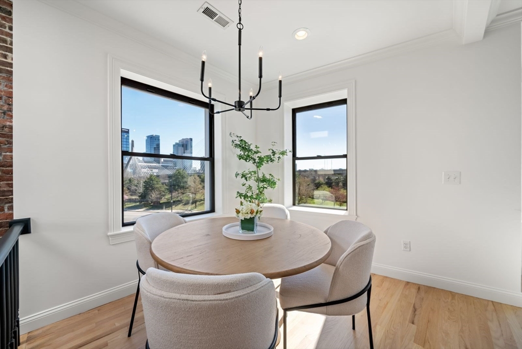 35 Rutherford Avenue, Unit 3 Boston, MA 02129 - Photo 5 of 28 a dining room with window and wooden floor