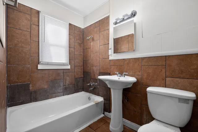 a bathroom with a sink a toilet and bathtub