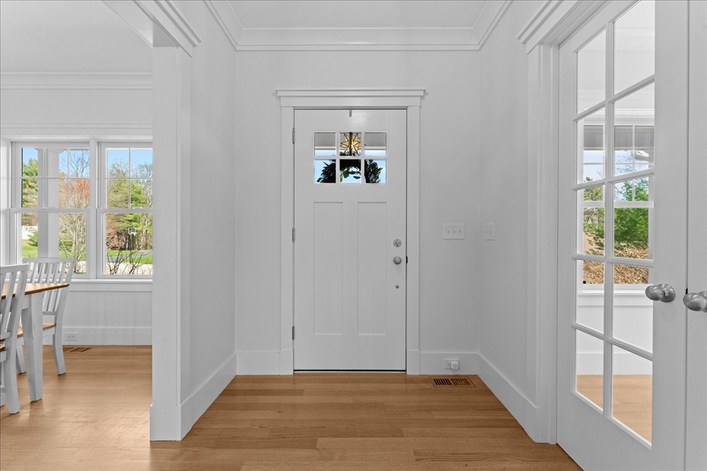 50 Quabbin Path Sutton, MA 01590 - Photo 8 of 42 a view of an entryway with wooden floor and a livingroom