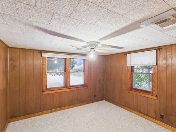 an empty room with windows and closet