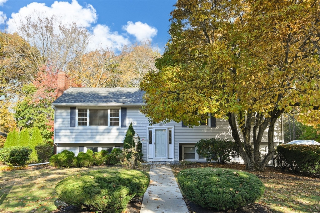 10 Strawberry Hill Road Andover, MA 01810 - Photo 1 of 41 a front view of a house with a garden