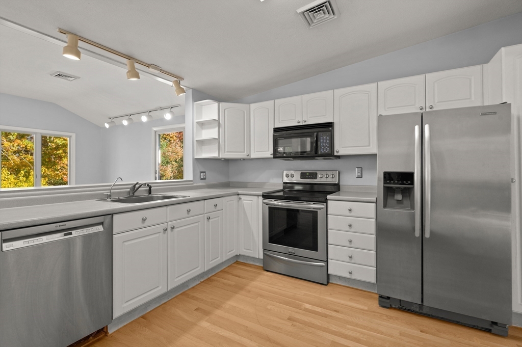 10 Strawberry Hill Road Andover, MA 01810 - Photo 11 of 41 a kitchen with granite countertop a refrigerator stove and sink