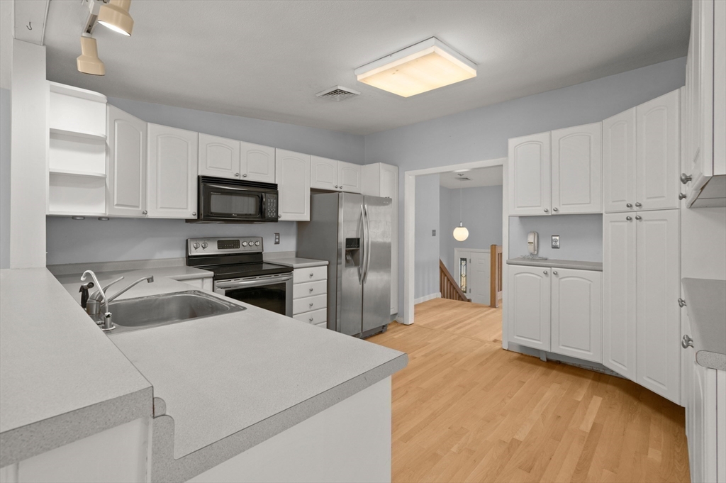 10 Strawberry Hill Road Andover, MA 01810 - Photo 13 of 41 a kitchen with a sink a stove and refrigerator