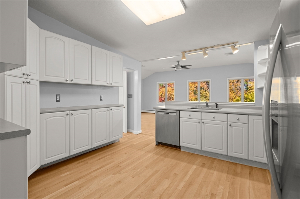 10 Strawberry Hill Road Andover, MA 01810 - Photo 14 of 41 a kitchen with cabinets wooden floor and a window
