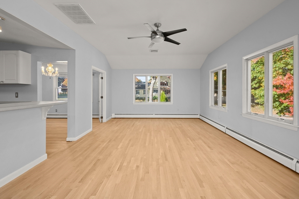 10 Strawberry Hill Road Andover, MA 01810 - Photo 17 of 41 a view of an empty room with a window and wooden floor