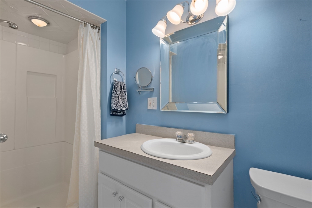 10 Strawberry Hill Road Andover, MA 01810 - Photo 21 of 41 a bathroom with a sink and a mirror