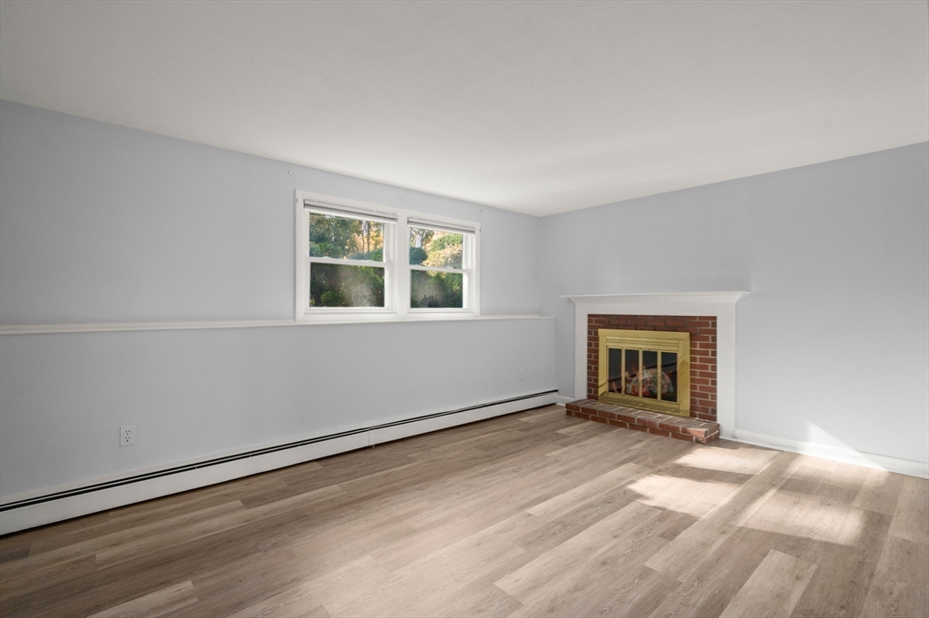 10 Strawberry Hill Road Andover, MA 01810 - Photo 24 of 41 a view of an empty room with wooden floor and a window