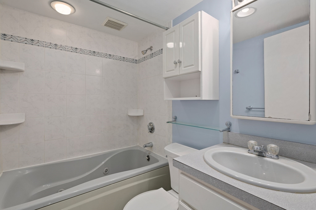 10 Strawberry Hill Road Andover, MA 01810 - Photo 27 of 41 a bathroom with a sink a toilet and shower