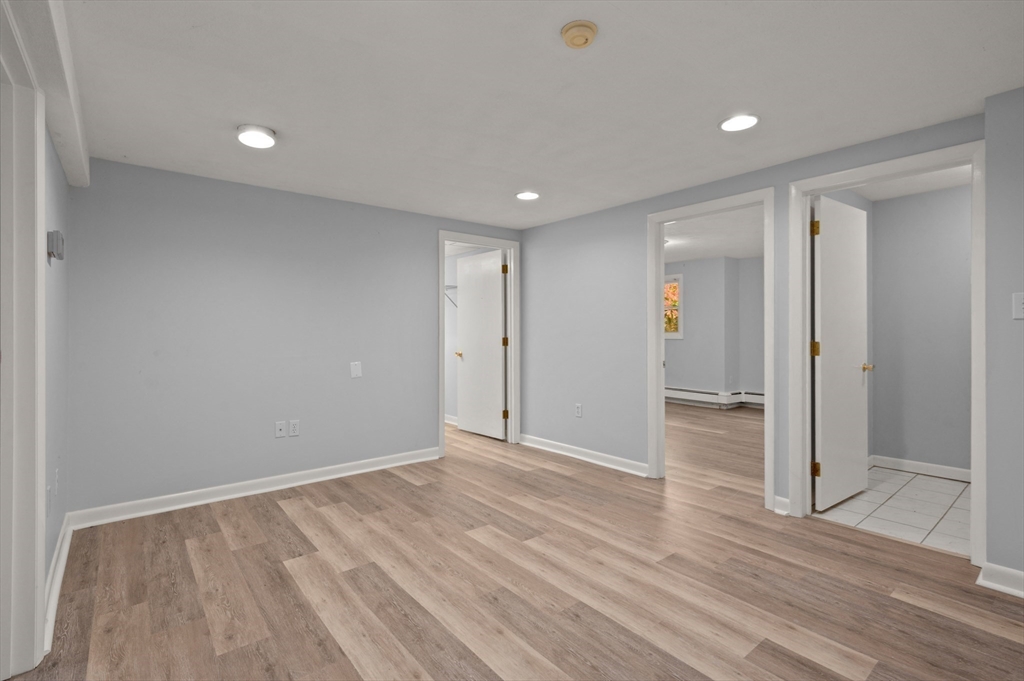 10 Strawberry Hill Road Andover, MA 01810 - Photo 28 of 41 a view of an empty room with wooden floor
