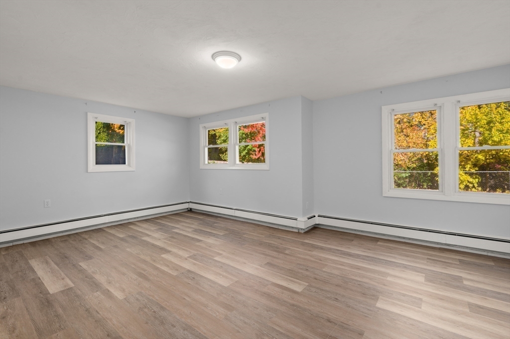 10 Strawberry Hill Road Andover, MA 01810 - Photo 29 of 41 a view of an empty room with a window and wooden floor