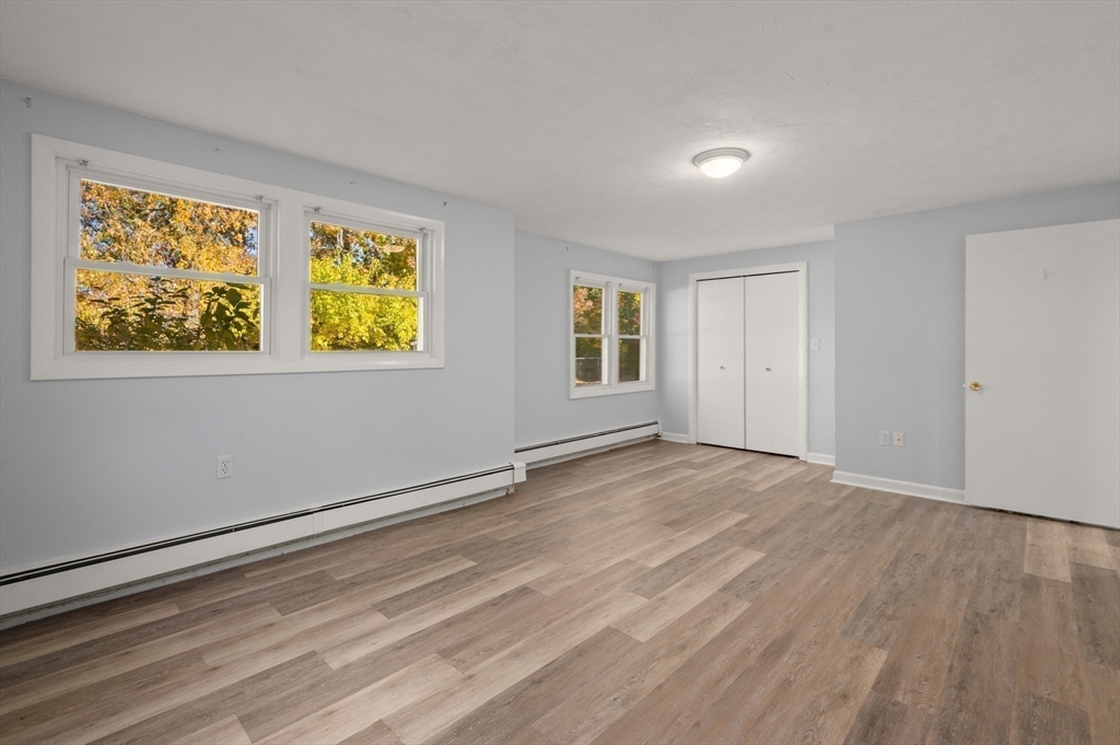10 Strawberry Hill Road Andover, MA 01810 - Photo 30 of 41 a view of an empty room with wooden floor and a window