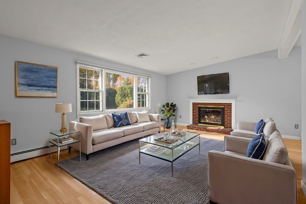 10 Strawberry Hill Road Andover, MA 01810 - Photo 4 of 41 a living room with furniture a rug a fireplace and a large window