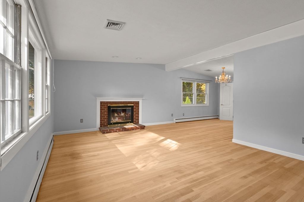10 Strawberry Hill Road Andover, MA 01810 - Photo 9 of 41 a view of an empty room with a window and fireplace