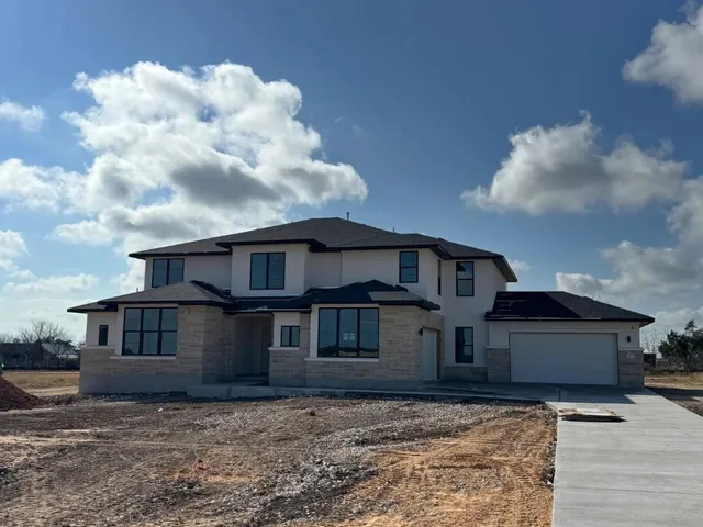 a front view of a house with many windows
